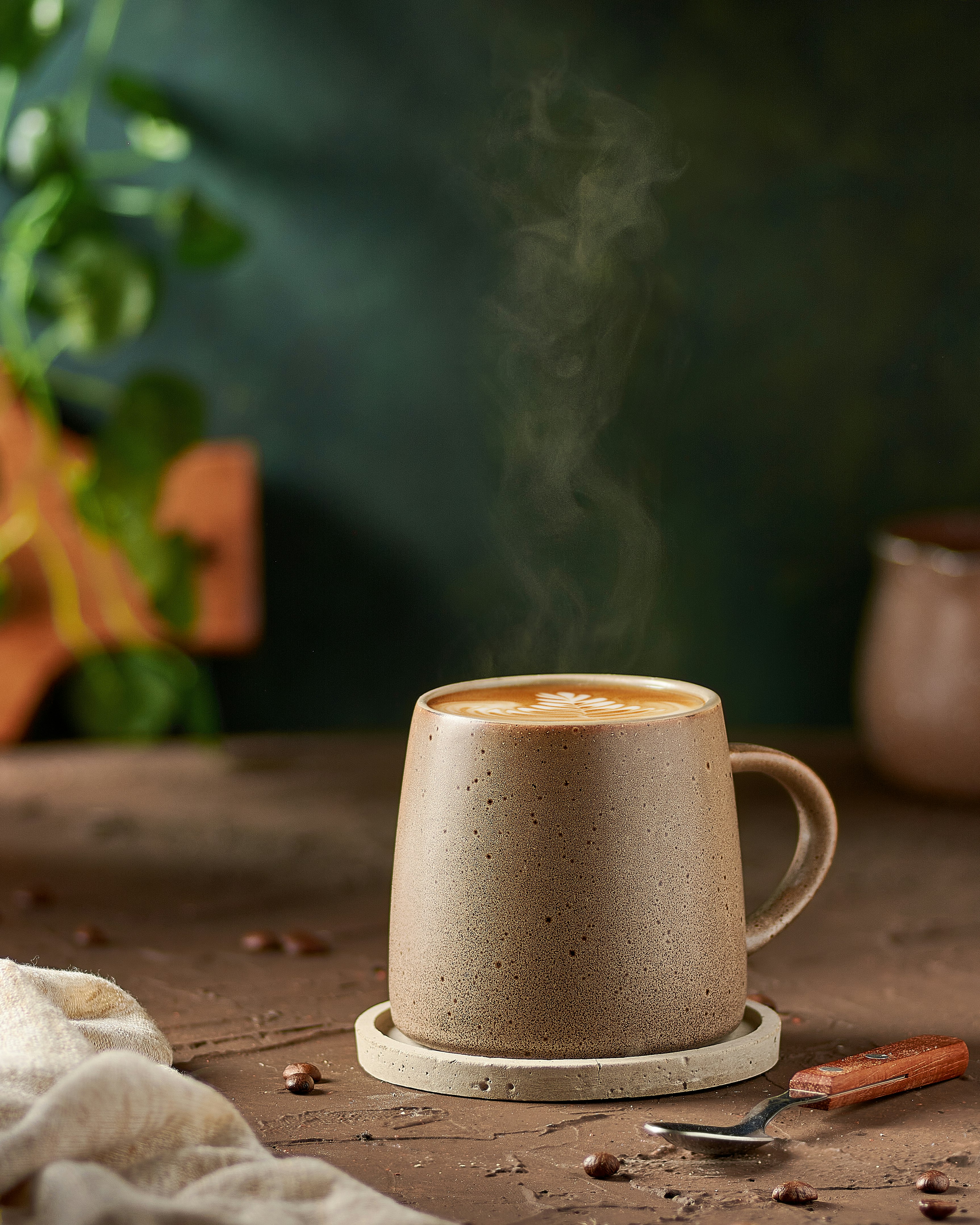 white ceramic mug on brown wooden table